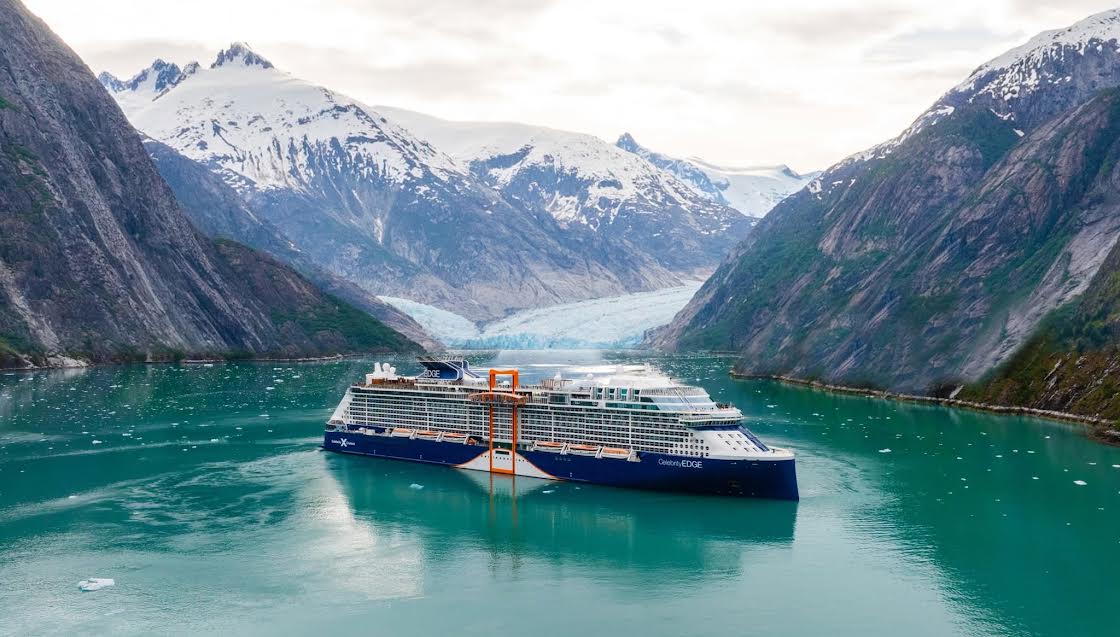 Celebrity Edge sailing an Alaskan fjord near a glacier