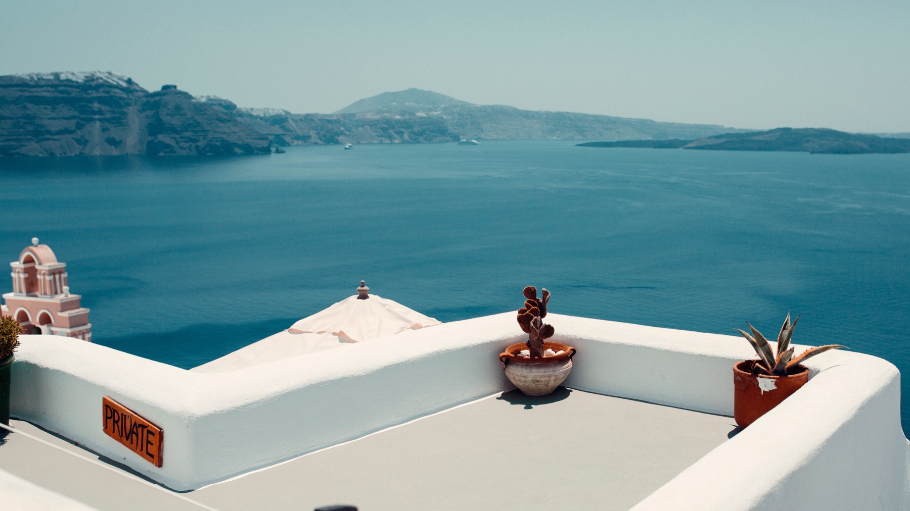 Whitewashed Santorini terrace overlooking the caldera