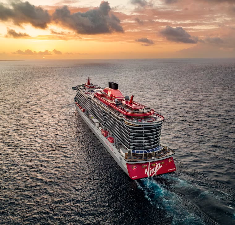 Virgin Voyages ship at sunset